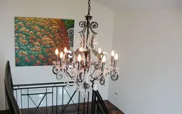 Feature chandelier installation in a stairwell